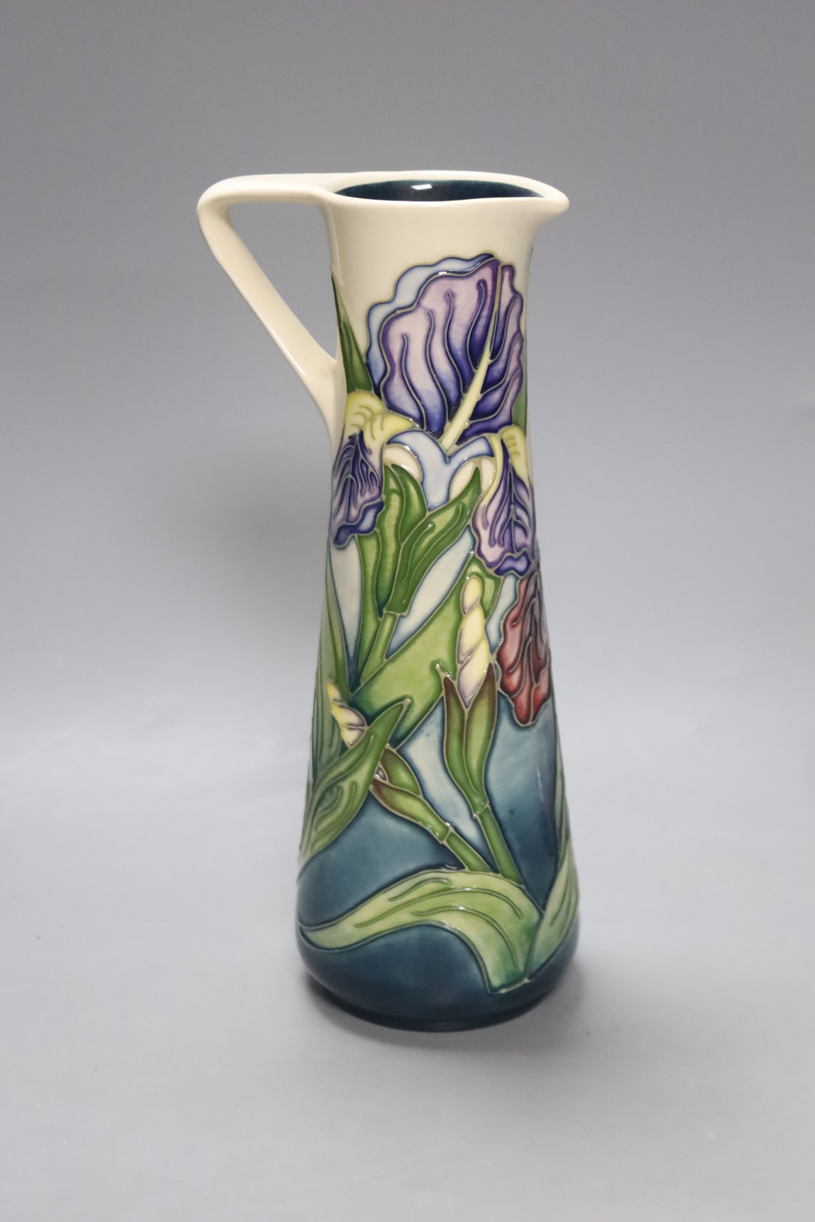 A Moorcroft iris pattern jug and two anenome dishes, together with four Cobridge vases